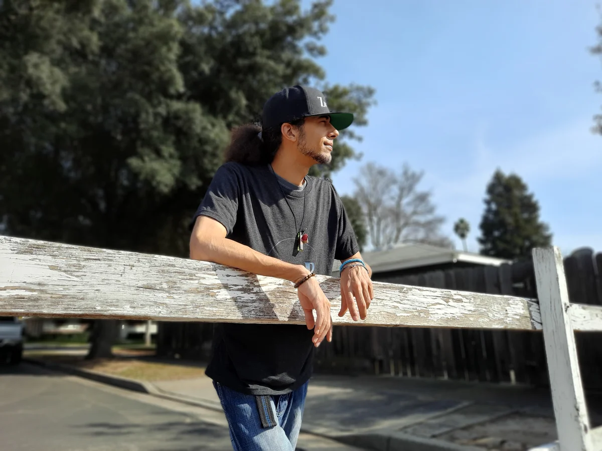 Z8phyR leaning on a wooden fence outdoors